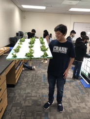 Student holding lettuce as part of the program
