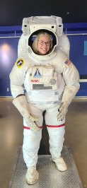 Teacher posing for photo in astronaut suit